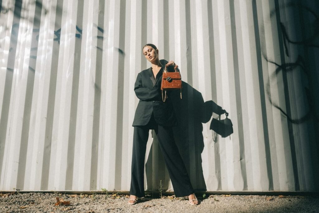 Woman carrying a red handbag in a fashion editorial