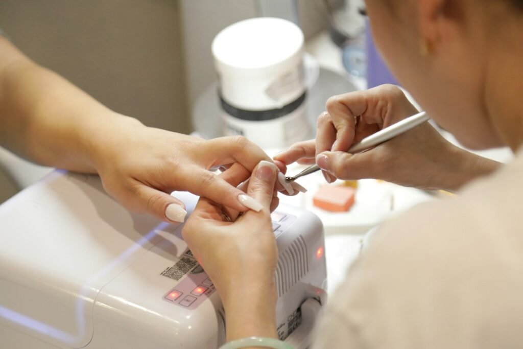 Professional nail salon manicure in progress